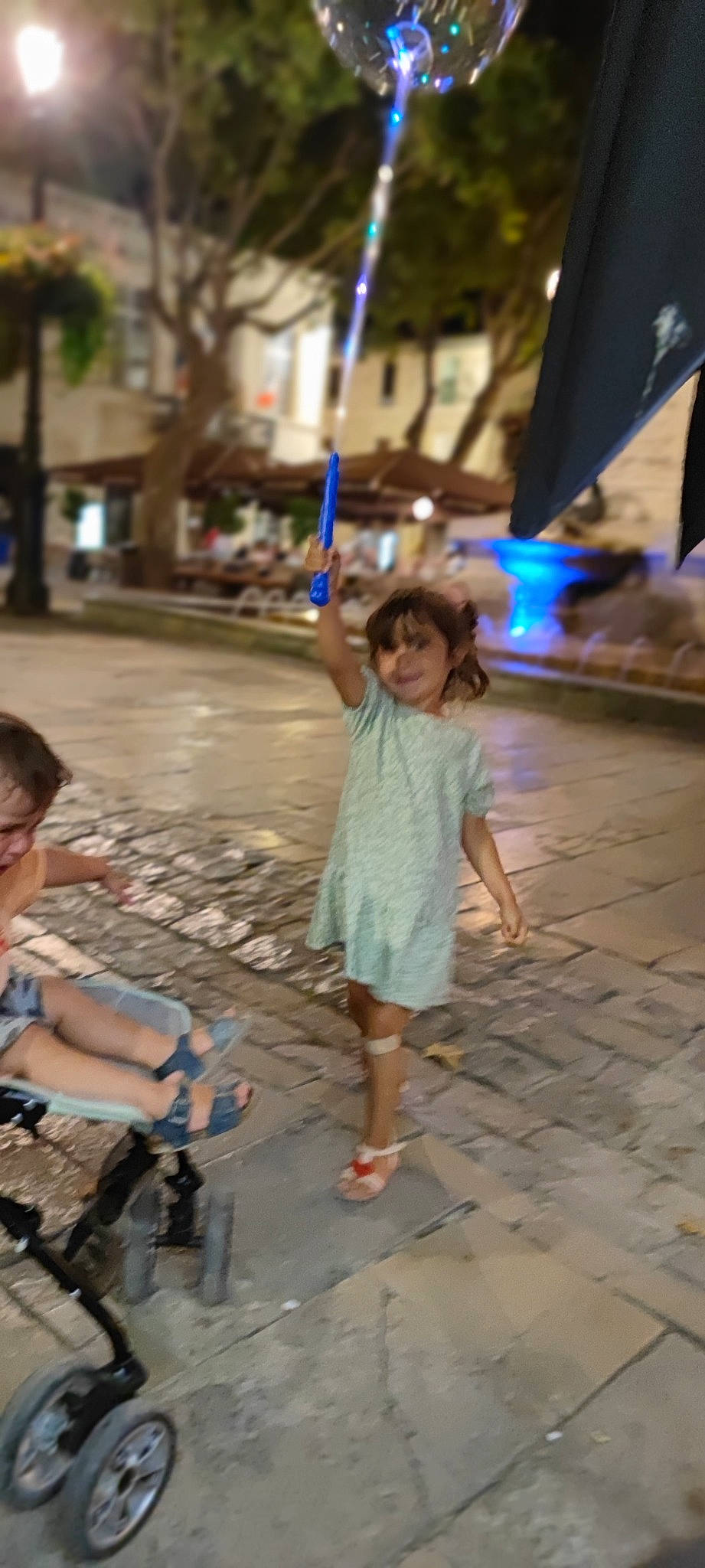 Emma participe au concours pour gagner de l'argent avec cette photo : child, city, event, flooring, fun, happy, human_leg, joy, leisure, pedestrian, person, recreation, road, road_surface, sandal, sidewalk, snapshot, street, temple, toddler