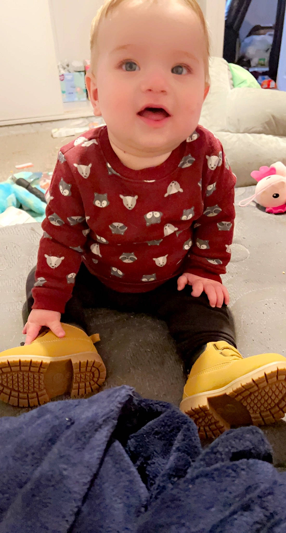 Bjorn is registered to the contest to win money with this photo: baby, baby_toddler_clothing, cheek, child, flooring, fun, happy, human, human_leg, mammal, pattern, person, sitting, skin, sleeve, sock, standing, thigh, toddler, wood