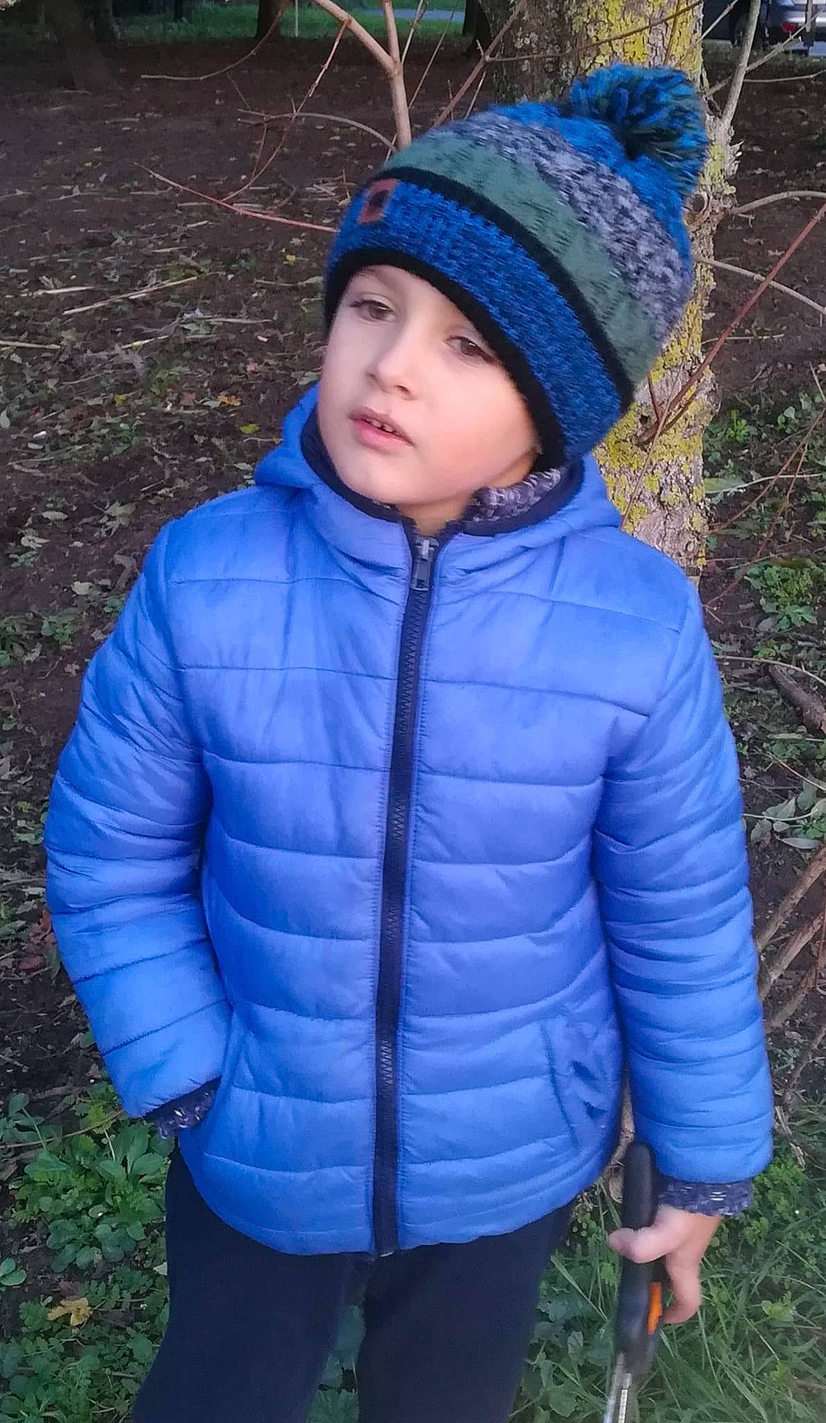 Mayron P. participe au concours pour gagner de l'argent avec cette photo : cap, clothing, electric_blue, eye, face, flash_photography, freezing, grass, head, headwear, hood, jacket, outerwear, people_in_nature, person, plant, sleeve, textile, toddler, tree