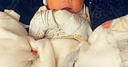 Naisaiah joined the competition — help win amazing prizes! baby, baby_clothes, bed, blanket, clothing, cozy, cute, expression, face, gloves, hat, indoors, infant, lying_down, newborn, person, portrait, soft, warm, wrapped