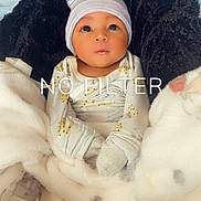 Naisaiah is registered to the contest to win money with this photo: baby, infant, blanket, hat, cute, swaddled, cozy, wrapped, face, eyes, newborn, sleepwear, indoor, soft, warm, child, adorable, portrait, gaze, lying_down