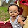 Julian joined the competition — help win amazing prizes! child, toddler, curly_hair, play_structure, outdoor, grass, trees, tongue_out, white_tank_top, playground, person, smiling, fun, daylight, young_child, closeup, happy, park, nature, casual