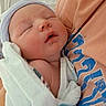 Tatum is registered to the contest to win money with this photo: newborn, baby, infant, pacifier, blanket, hat, sleeping, person, arms, closeup, hospital, skin, clothing, resting, cute, care, tender, comfort, portrait, human