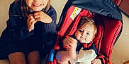 Léony participe au concours pour gagner de l'argent avec cette photo : baby, baby_carrier, cabinet, child, cute, feet, floor, furniture, girl, happy, home, indoor, infant, leather_chair, person, red, sandals, smile, sparkles, toddler