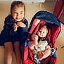 baby, baby_carrier, cabinet, child, cute, feet, floor, furniture, girl, happy, home, indoor, infant, leather_chair, person, red, sandals, smile, sparkles, toddler