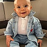 baby, denim_jacket, denim_pants, white_shirt, couch, cushion, smile, child, cute, portrait, indoor, sitting, clothing, face, head, hand, footwear, cozy, happy, young_child