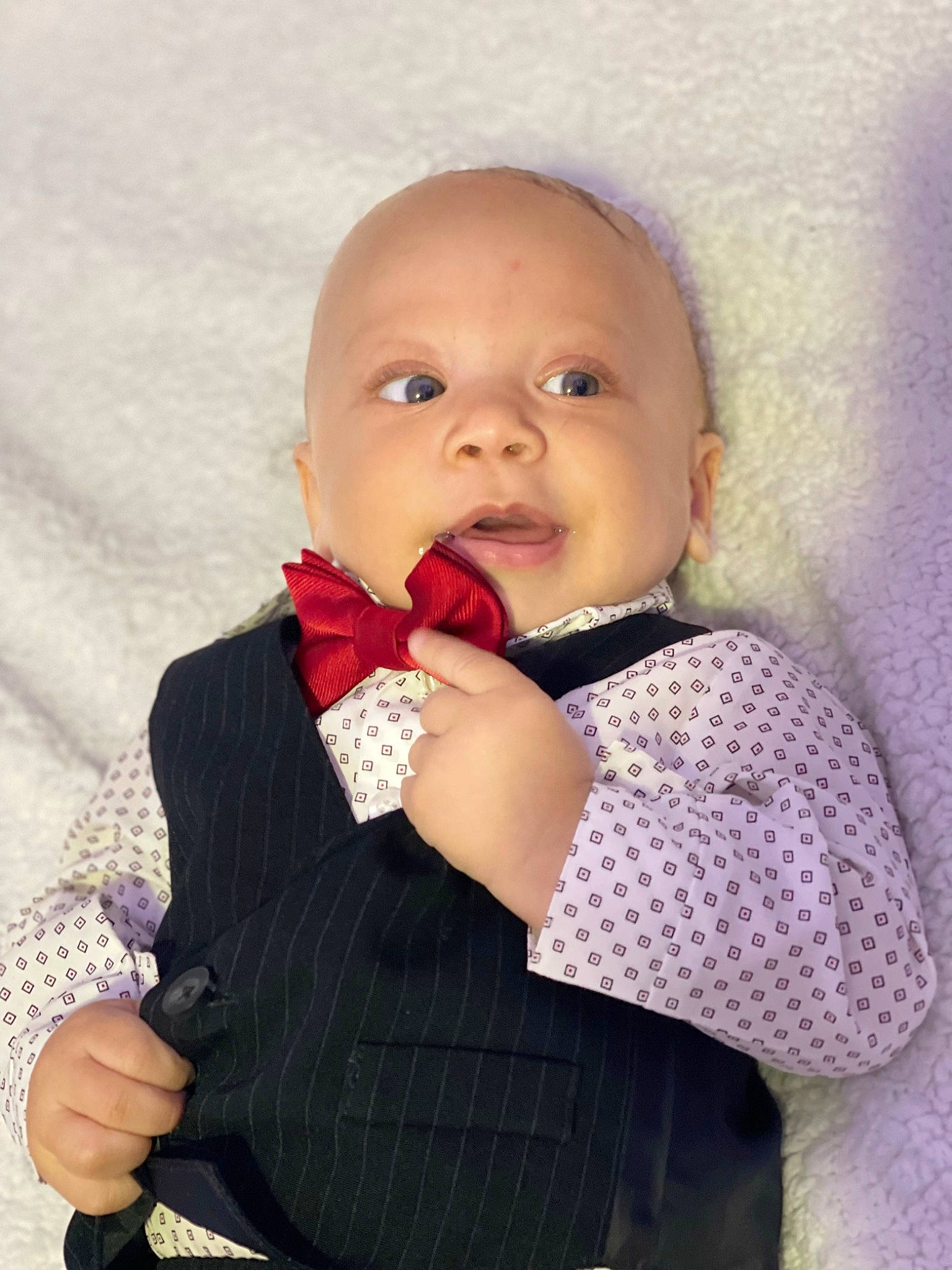 Jayden is registered to the contest to win money with this photo: baby, baby_toddler_clothing, cheek, child, eyelash, fashion_accessory, formal_wear, gesture, happy, iris, lip, magenta, neck, nose, pattern, person, pink, sleeve, thumb, tie