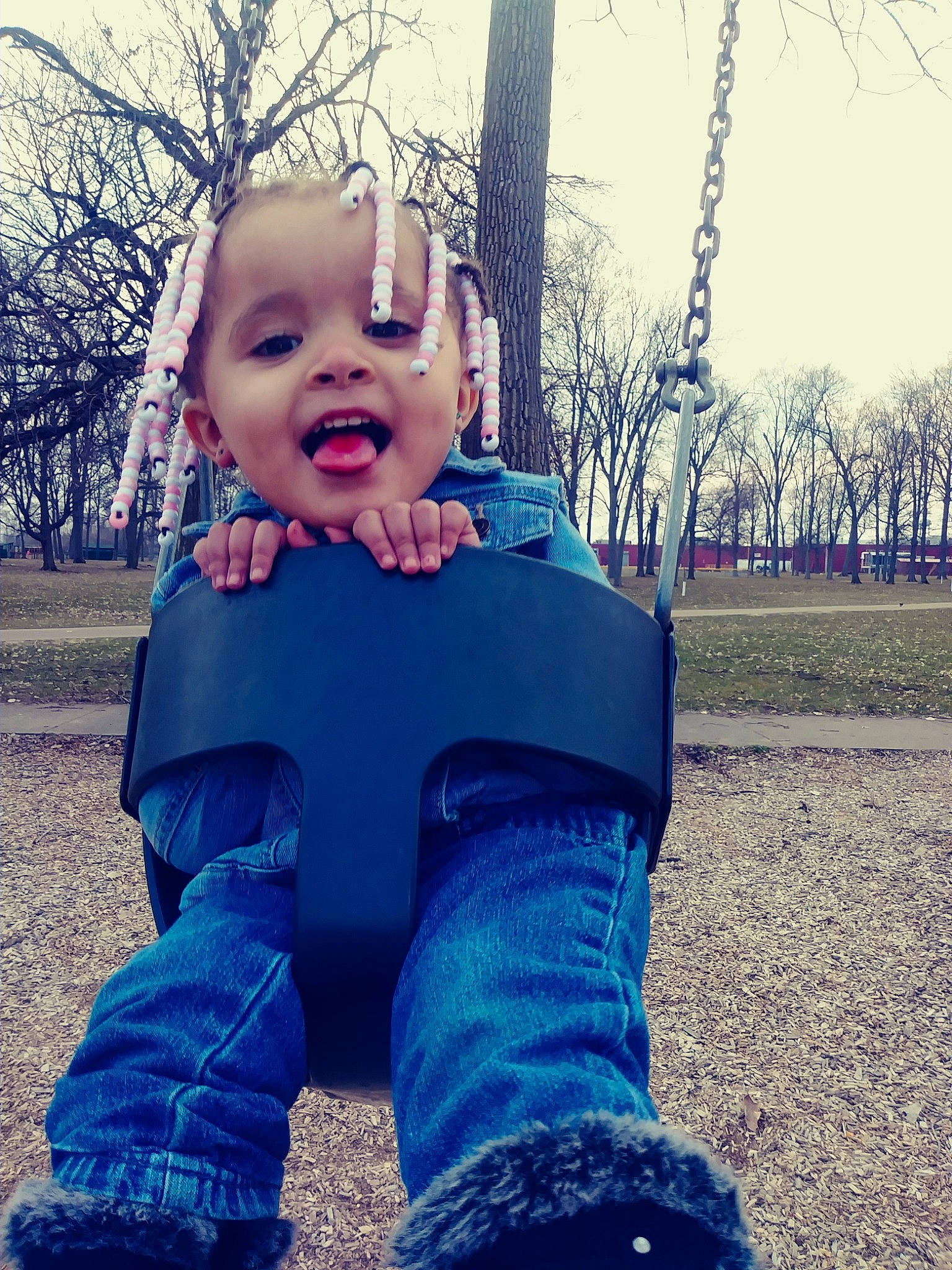 Akira joined the competition — help win amazing prizes! baby, blue, cheek, child, cool, eye, face, facial_expression, grass, head, jeans, nose, people, person, public_space, skin, sky, smile, swing, toddler