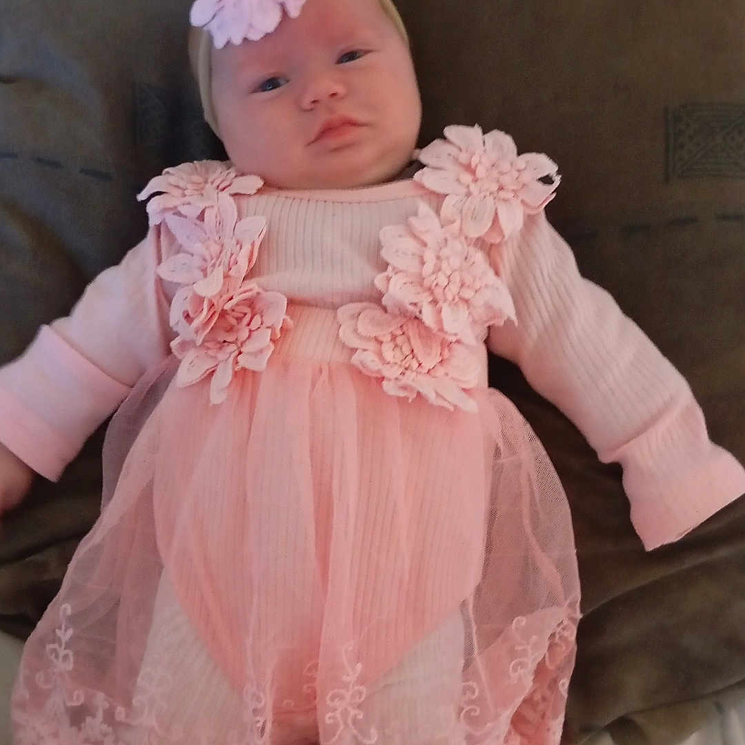 Lyna participe au concours pour gagner de l'argent avec cette photo : baby, pink_dress, flower_headband, infant, lying_down, soft_surface, white_tights, cute, small_hands, portrait, child, indoors, clothing, baby_fashion, adorable, young_child, headwear, baby_girl, resting, baby_face