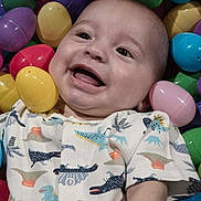 Oakley joined the competition — help win amazing prizes! baby, smiling, face, child, dinosaur_print, easter_eggs, colorful, plastic_eggs, cute, happy, infant, playful, clothing, portrait, indoors, young_child, head, skin, eyes, mouth