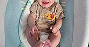 Oakley joined the competition — help win amazing prizes! baby, infant, smiling, winnie_the_pooh, tshirt, baby_seat, cushion, happy, child, cute, feet, hands, indoor, person, young_child, playful, comfortable, clothing, portrait, relaxing