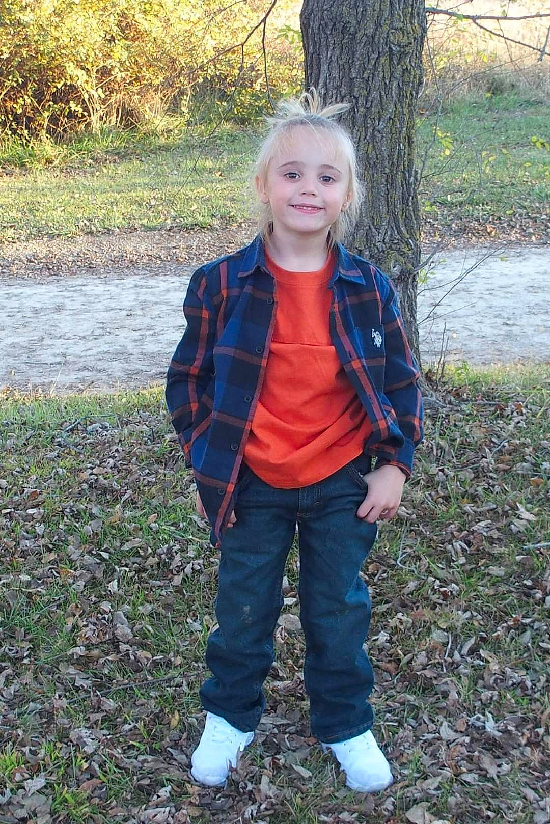 Maverick is registered to the contest to win money with this photo: denim, electric_blue, face, forest, grass, happy, human_body, jacket, joy, pattern, people_in_nature, person, plaid, plant, sleeve, smile, toddler, tree, wilderness, winter