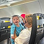 Andrew joined the competition — help win amazing prizes! baby, headphones, woman, airplane, seat, smile, child, travel, cabin, clothing, person, holding, earmuffs, happy, transportation, seatback, glasses, infant, family, inside
