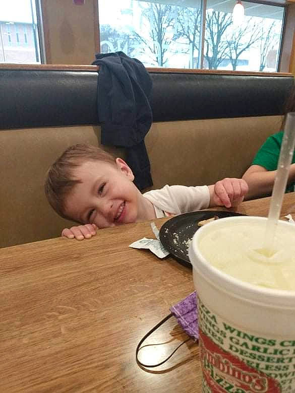 Taysom is registered to the contest to win money with this photo: bowl, comfort, couch, cuisine, cup, dish, drink, flooring, food, hardwood, ingredient, joy, kitchen_utensil, person, smile, spoon, table, tableware, toddler, varnish