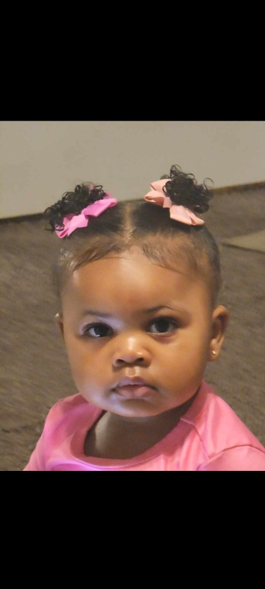 Kimber is registered to the contest to win money with this photo: toddler, child, face, pink_bow, curly_hair, indoors, carpet, cute, portrait, earrings, pink_clothing, baby, person, young_child, expressionless, hair_style, eyebrows, skin, closeup, sitting