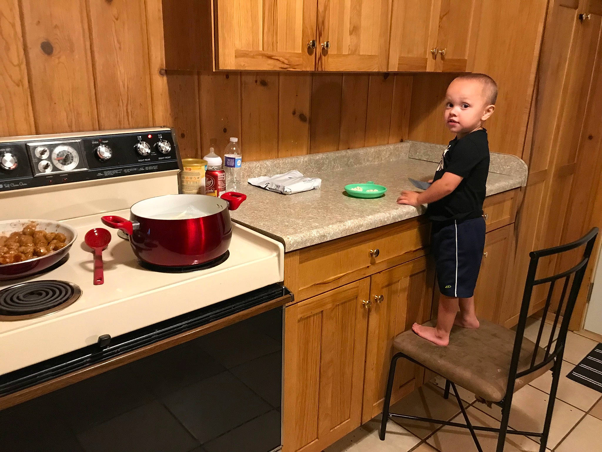James joined the competition — help win amazing prizes! cabinetry, cooking, cooktop, countertop, cupboard, drawer, flooring, food, hardwood, interior_design, kitchen, kitchen_appliance, person, plate, recipe, room, shorts, tableware, toddler, wood