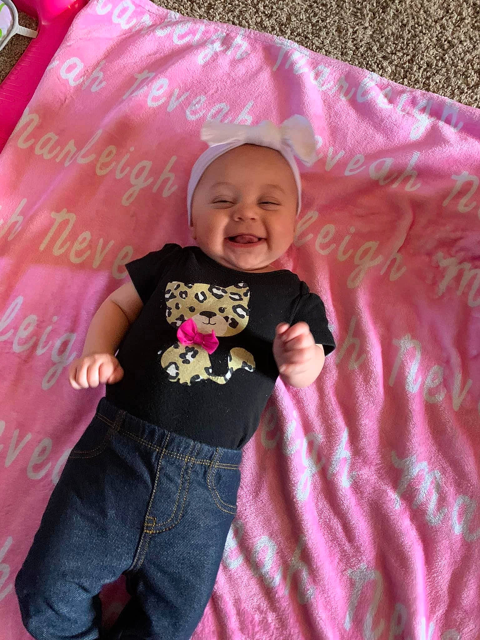 Marleigh is registered to the contest to win money with this photo: baby, baby_toddler_clothing, child, fun, happy, jeans, linens, magenta, pattern, person, pink, play, purple, sitting, skin, sleeve, smile, t_shirt, textile, toddler
