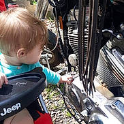 Alexa joined the competition — help win amazing prizes! toddler, child, baby, motorcycle, engine, vehicle, outdoor, curious, reaching, turquoise_shirt, blond_hair, profile, portrait, machinery, chrome, metal, mechanic, sunlight, gravel, jeep