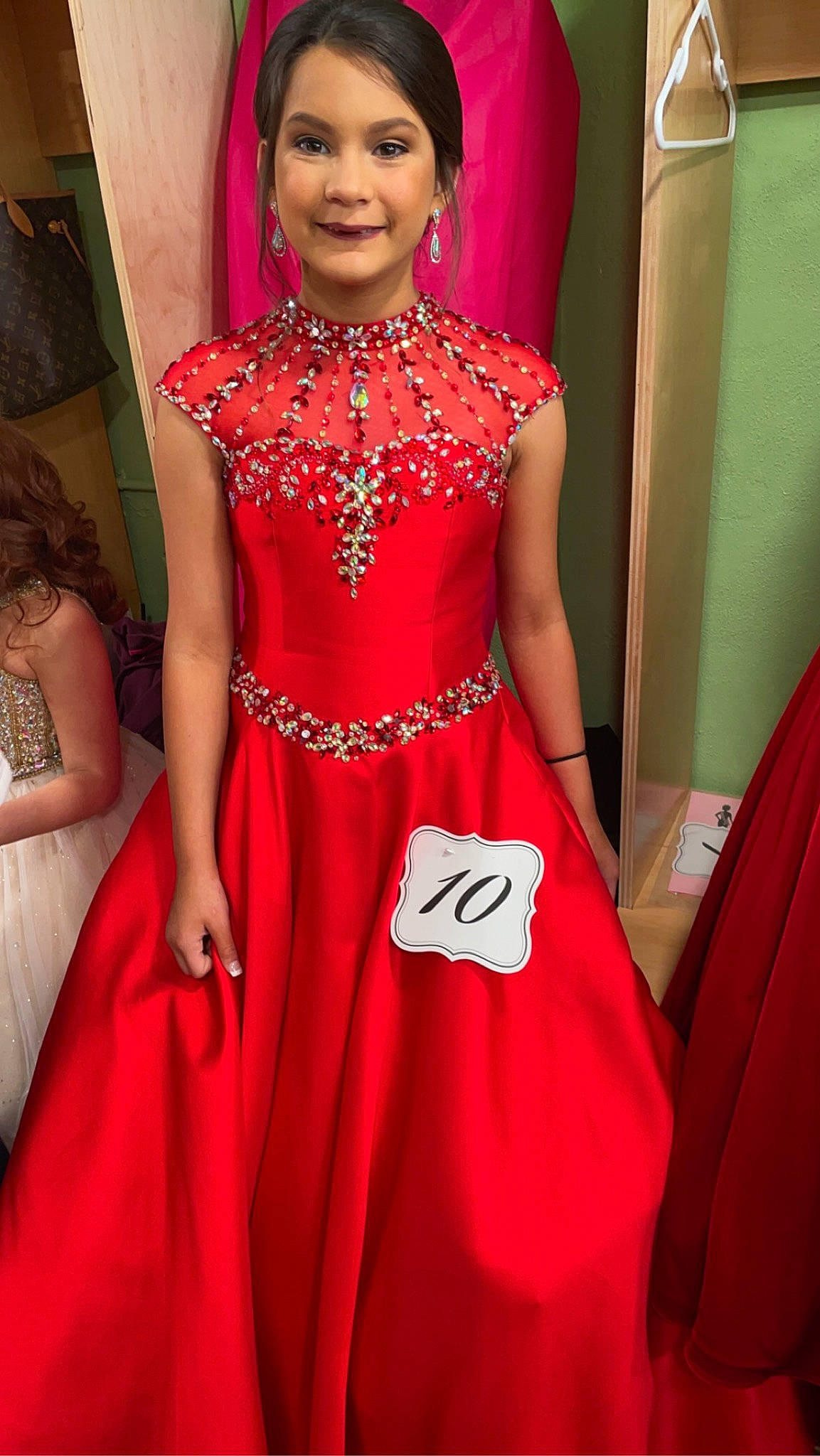 Brilynn joined the competition — help win amazing prizes! beauty, bridal_party_dress, day_dress, dress, embellishment, event, fashion_design, fashion_model, flooring, formal_wear, gown, hairstyle, happy, joy, magenta, neck, one_piece_garment, person, pink, red