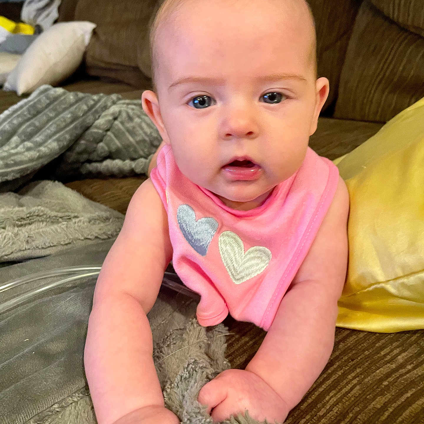 Kennedy is registered to the contest to win money with this photo: baby, babycrawling, blanket, couch, crawling, cushion, face, furniture, head, homedecor, newborn, person, photography, portrait, sitting