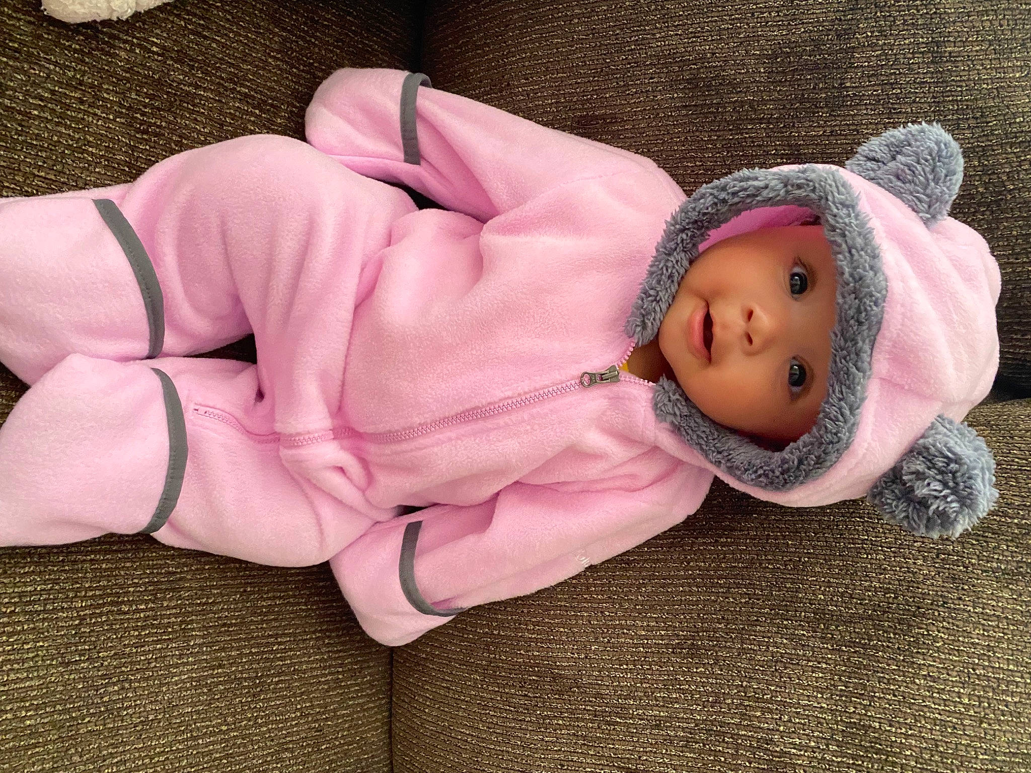 Averi is registered to the contest to win money with this photo: baby, baby_products, baby_sleeping, baby_toddler_clothing, beanie, cheek, child, comfort, fashion_accessory, fur, headwear, human_body, knit_cap, linens, magenta, outerwear, person, pink, sitting, sleeve