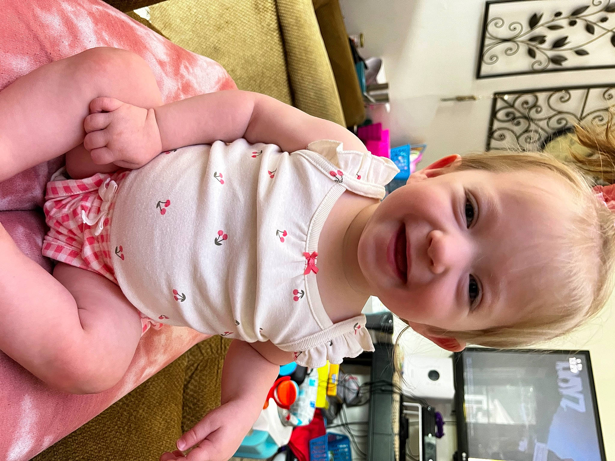Everleigh is registered to the contest to win money with this photo: baby, baby_products, baby_toddler_clothing, cheek, child, comfort, eye, facial_expression, finger, happy, joy, mouth, nose, pattern, people, person, picture_frame, product, room, skin