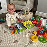 Chester joined the competition — help win amazing prizes! baby, child, smiling, play_mat, toys, book, indoor, armchair, basket, colorful, floor, happy, cute, infant, pajamas, room, playtime, development, early_learning, portrait