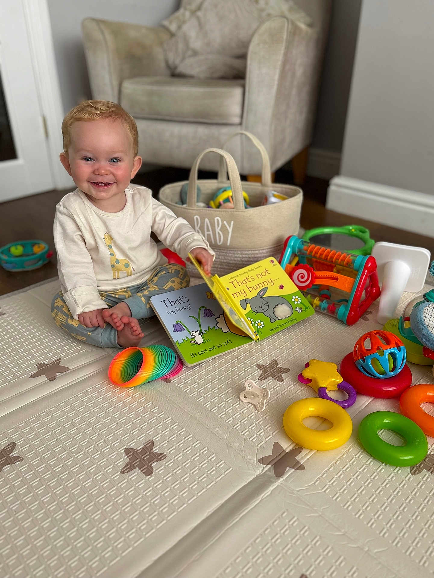 Chester joined the competition — help win amazing prizes! baby, child, smiling, play_mat, toys, book, indoor, armchair, basket, colorful, floor, happy, cute, infant, pajamas, room, playtime, development, early_learning, portrait