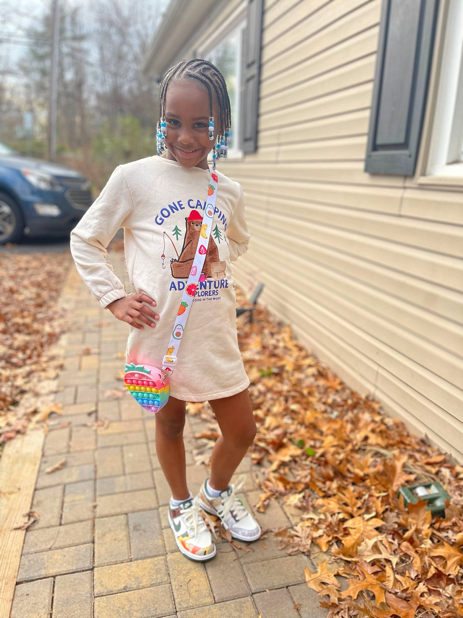 Paige is registered to the contest to win money with this photo: asphalt, car, child, cool, electric_blue, eyewear, human_leg, joy, pattern, person, road, road_surface, sandal, sidewalk, sleeve, standing, street_fashion, tire, toddler, waist