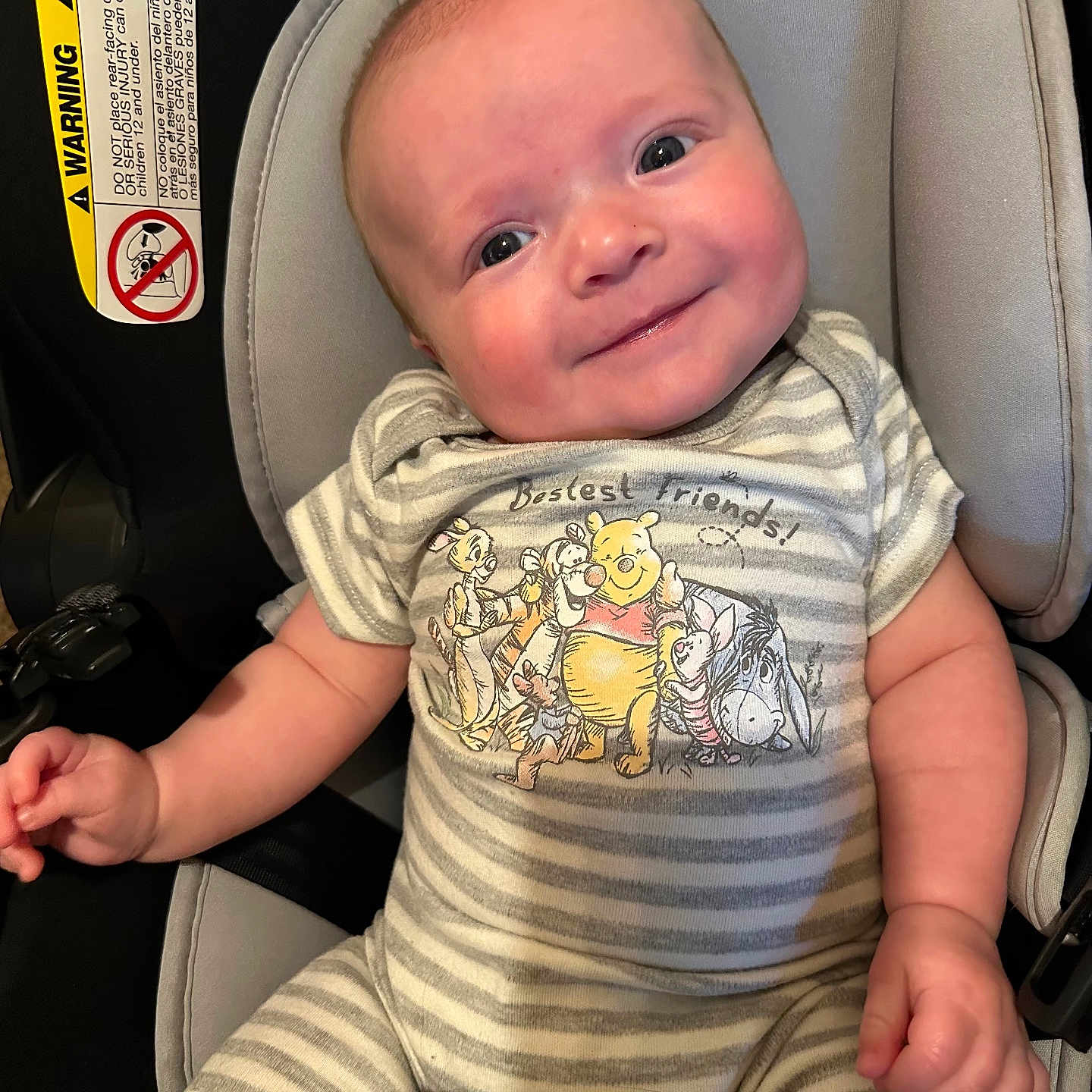 Riley is registered to the contest to win money with this photo: accessories, baby, belt, bodypart, clothing, cushion, face, finger, hand, happy, head, homedecor, person, photography, portrait, sitting, smile, t_shirt, transportation, vehicle