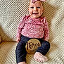 Madelyn joined the competition — help win amazing prizes! baby, infant, pink_bow, floral_top, dark_pants, pink_socks, wooden_sign, three_months, smiling, sitting, blanket, cozy, indoor, cute, child, headband, portrait, happy, texture, person