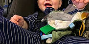 Emerson joined the competition — help win amazing prizes! baby, child, car_seat, smiling, striped_clothing, toy, blanket, indoor, infant, happy, seat_belt, soft_toy, clothing, person, cute, young_child, playful, comfort, baby_toys, closeup