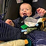 baby, child, car_seat, smiling, striped_clothing, toy, blanket, indoor, infant, happy, seat_belt, soft_toy, clothing, person, cute, young_child, playful, comfort, baby_toys, closeup