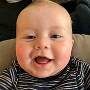 Emerson joined the competition — help win amazing prizes! baby, smiling, face, child, striped_shirt, mohawk, happy, infant, closeup, person, cute, cheeks, mouth_open, eyes, clothing, sitting, indoor, blanket, soft, portrait