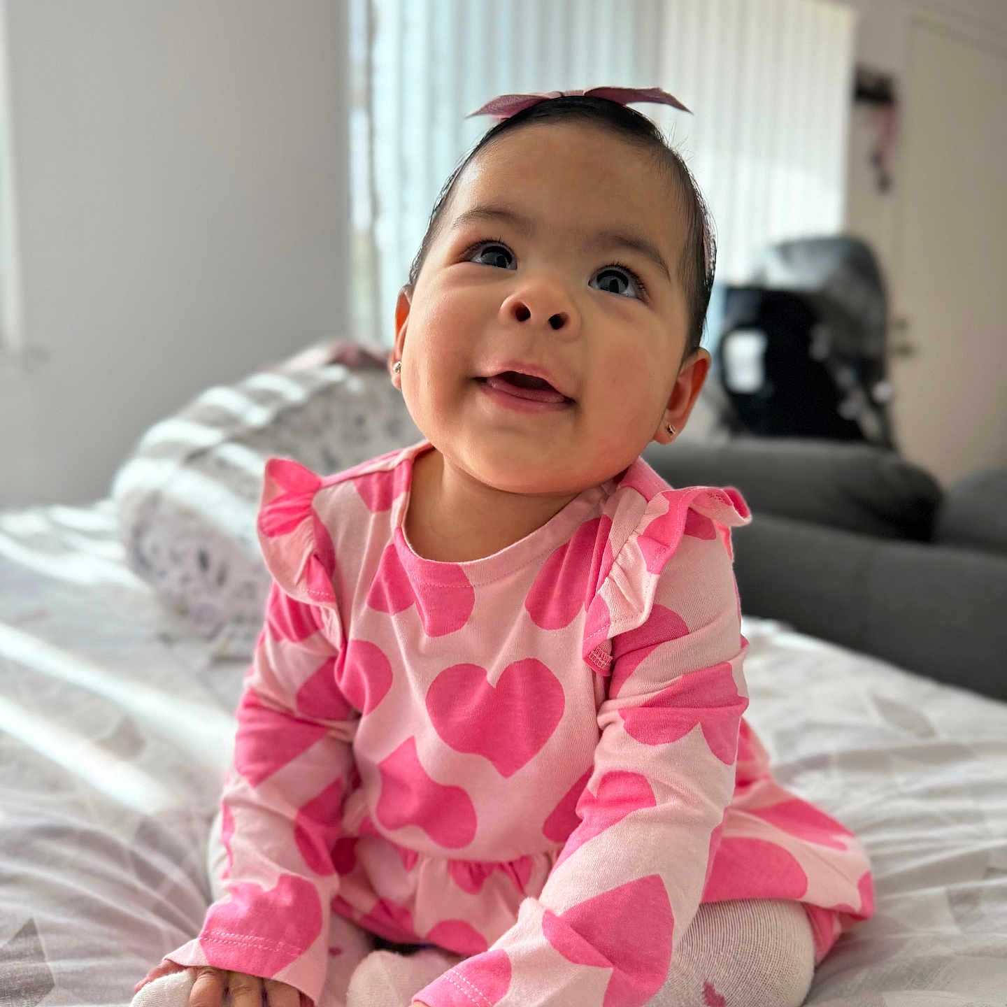 Leah joined the competition — help win amazing prizes! baby, bed, bedroom, bodypart, clothing, couch, face, finger, furniture, hand, happy, head, indoors, pajamas, person, photography, portrait, room, sitting, smile