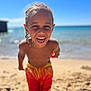 child, smiling, beach, ocean, sand, sunny, summer, swim_trunks, braided_hair, happy, shore, water, outdoor, fun, playful, sunlight, young, bare_chest, vacation, holiday