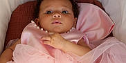 Maïna participe au concours pour gagner de l'argent avec cette photo : baby, infant, pink_dress, pearls, curly_hair, bassinet, cushion, soft_fabric, portrait, close_up, child, sleeping_area, cute, face, hand, indoors, cozy, tulle, newborn, looking_up