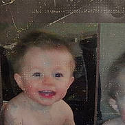 Tommy is registered to the contest to win money with this photo: baby, child, smiling, face, teeth, bare_shoulders, old_photo, scratched, blurry, portrait, indoor, young_child, head, skin, person, closeup, cute, expression, infant, happy