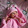 baby, infant, pink_towel, pacifier, bunny_hood, blanket, cute, child, newborn, sleepwear, soft_texture, lying_down, indoor, close_up, adorable, portrait, baby_girl, pastel_colors, cozy, wrapped