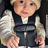 baby, infant, child, car_seat, knit_hat, pajamas, sun_pattern, straps, blanket, hands, face, eyes, cute, cozy, indoors, security, portrait, young, smiling, clothing