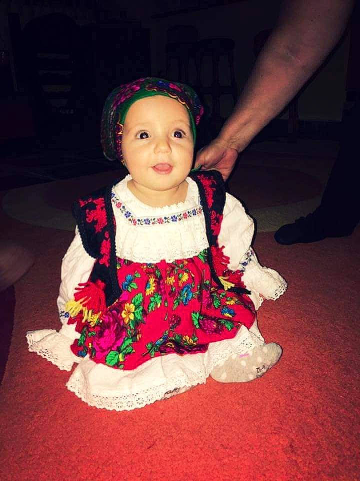 Briana joined the competition — help win amazing prizes! cheek, child, child_model, doll, dress, headwear, person, pink, sitting, skin, smile, textile, toddler, toy, tradition