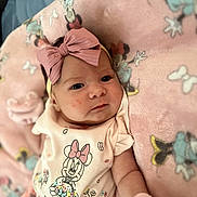 Dalila joined the competition — help win amazing prizes! baby, infant, pink_bow, headband, minnie_mouse, blanket, clothing, cute, face, portrait, lying_down, soft_toys, child, indoor, apparel, baby_mittens, expression, young_child, cartoon_character, cozy