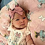 baby, infant, pink_bow, headband, minnie_mouse, blanket, clothing, cute, face, portrait, lying_down, soft_toys, child, indoor, apparel, baby_mittens, expression, young_child, cartoon_character, cozy
