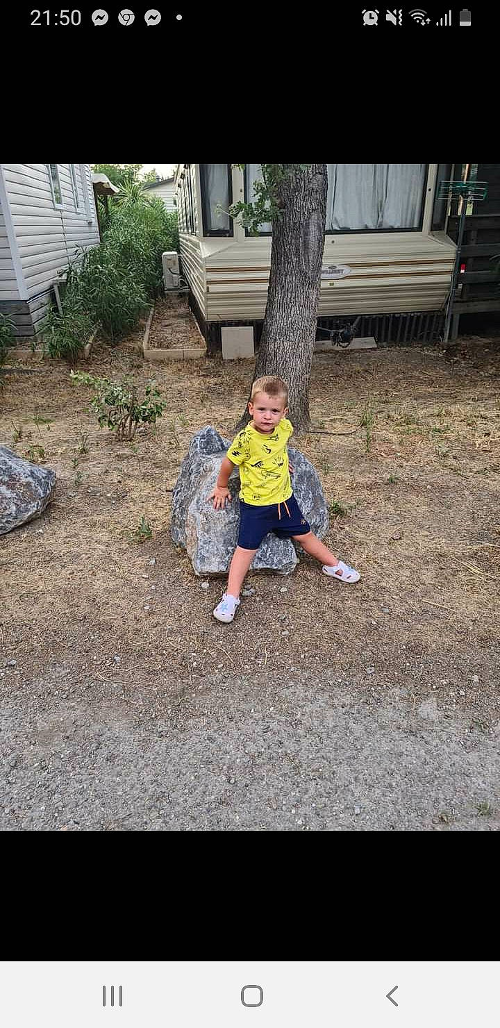 Theo a rejoint le concours — aidez-le/la à gagner de superbes lots ! asphalt, child, driveway, flooring, fun, garden, grass, landscape, lawn, leisure, person, plant, recreation, road_surface, shorts, sidewalk, sitting, soil, t_shirt, toddler