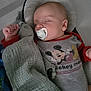 Maël participe au concours pour gagner de l'argent avec cette photo : baby, sleeping, pacifier, blanket, soft_toy, crib, mickey_mouse, clothing, infant, child, cute, peaceful, resting, indoors, bed, head_support, pajamas, comfort, toddler, nap