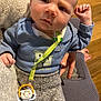 Tate joined the competition — help win amazing prizes! baby, blue_shirt, casual, chair, closeup, clothing, comfort, cute, expression, face, hand, indoor, infant, knitted_fabric, pacifier, person, seated, texture, wood_floor, young_child