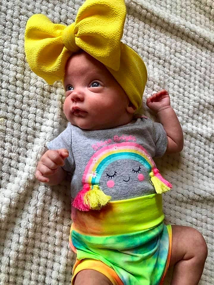 Bexley is registered to the contest to win money with this photo: baby, baby_toddler_clothing, cheek, chin, eye, face, green, happy, head, human_body, iris, lip, mouth, nose, person, photograph, pink, skin, sleeve, textile