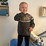 Aykan participe au concours pour gagner de l'argent avec cette photo : child, toddler, smile, sweater, striped_socks, changing_pad, baby_essentials, diapers, lotion, bottle, indoor, shelf, bonsai_tree, wooden_box, clothing, person, wall, floor, happy, standing