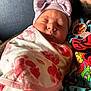 Lexani joined the competition — help win amazing prizes! newborn, baby, sleeping, blanket, hat, bow, floral, striped, face, person, child, clothing, jewelry, pendant, cartoon, colorful, cozy, closeup, portrait, indoor
