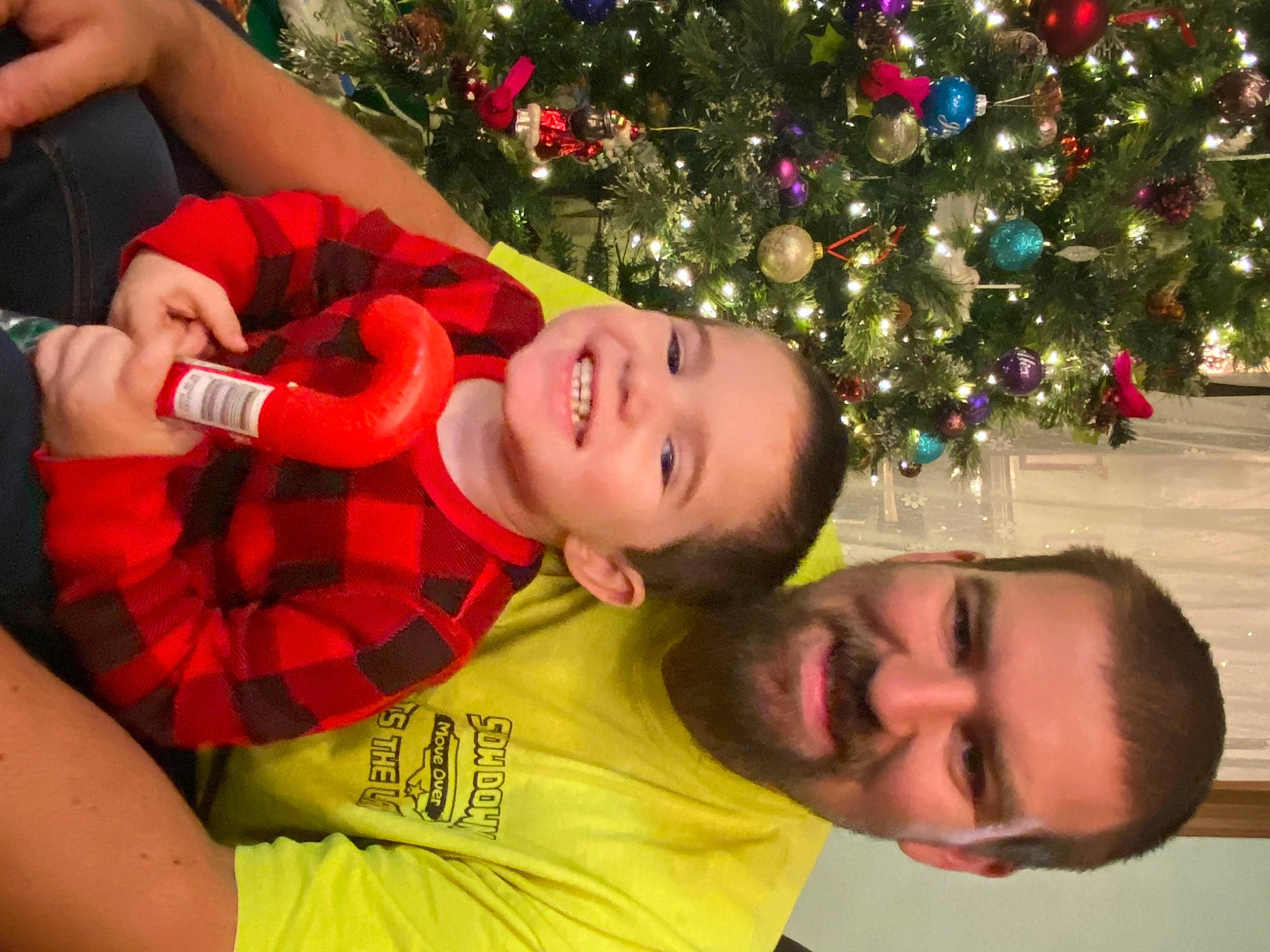 Dallas joined the competition — help win amazing prizes! christmas_decoration, christmas_ornament, christmas_tree, facial_expression, fun, grass, happy, head, holiday_ornament, human_body, joy, light, muscle, organ, people, people_in_nature, person, plant, smile, tartan